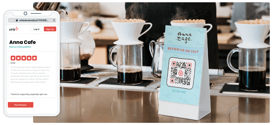 A table tent in front of some cups of coffee featuring a QR Code asking for Yelp reviews.
